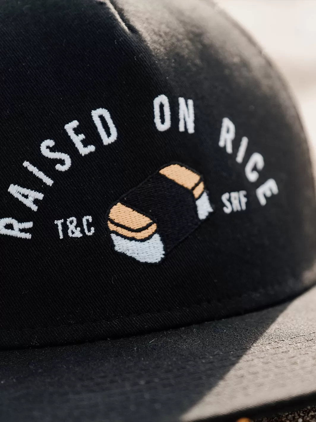 T&C Surf Kids Raised On Musubi Trucker Cap